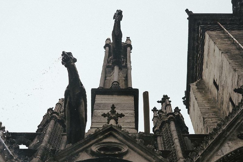 Plastic piping (right) replaces a fallen gargoyle on the Notre Dame Cathedral in Paris. “Everywhere the stone is eroded, and the more the wind blows, the more all of these little pieces keep falling,” cathedral spokesman Andre Finot said. “It’s spinning out of control everywhere.” 