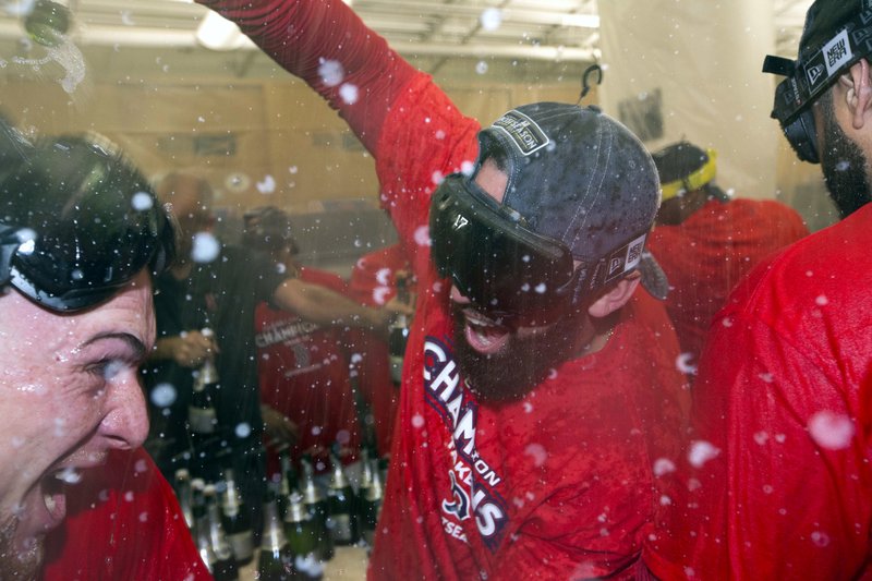 Boston Red Sox's Deven Marrero, right, celebrates in the clubhouse with Christian Vazquez after the Red Sox defeated the Houston Astros 6-3 in a baseball game to clinch the American League East division in Boston, Saturday, Sept. 30, 2017. (AP Photo/Michael Dwyer)