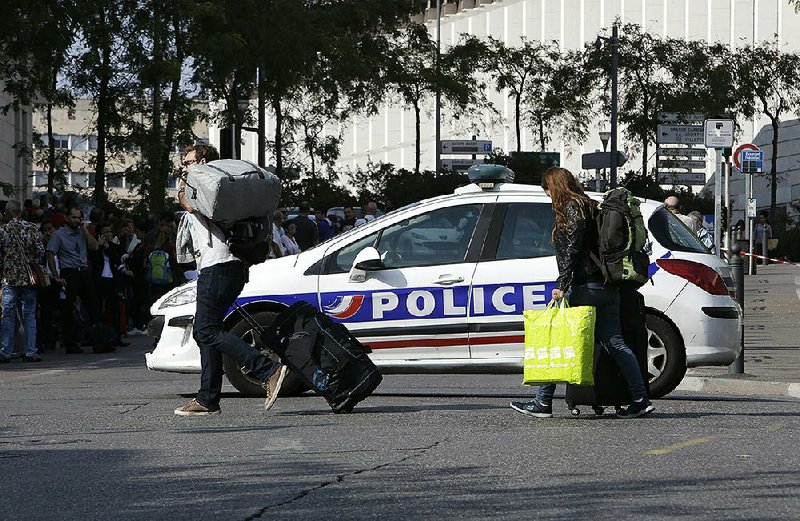 A police car blocks passengers’ access to the main train station in Marseille, France, on Sunday after a knife attack. 