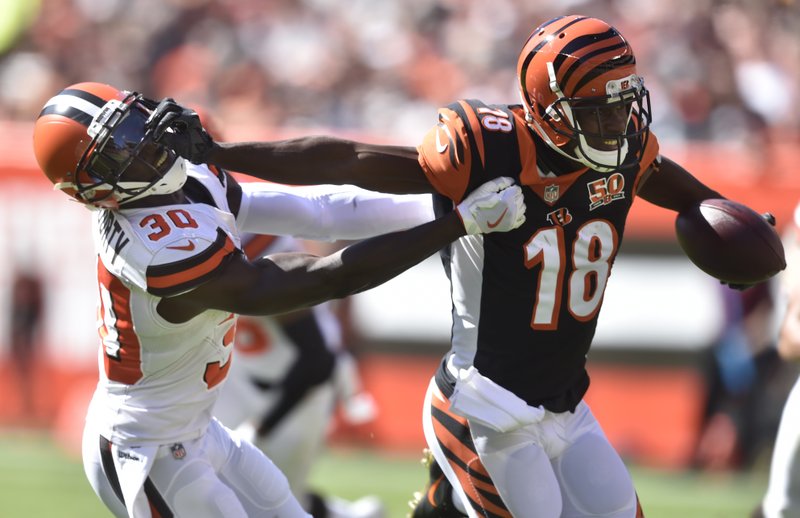 Cincinnati Bengals wide receiver A.J. Green (18) blocks Cleveland Browns defensive back Jason McCourty (30) in the first half of an NFL football game, Sunday, Oct. 1, 2017, in Cleveland. (AP Photo/David Richard)