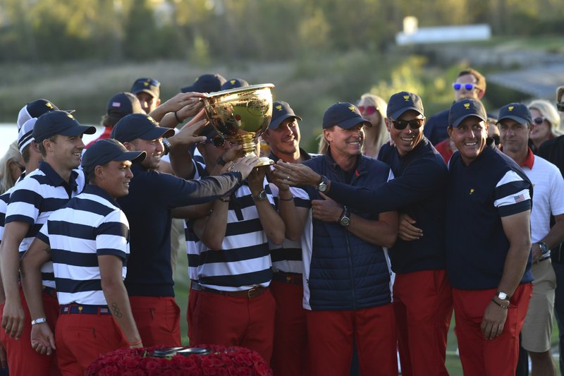 President Donald Trump participates in presenting the Presidents Cup to the United States team at the Jersey City Golf Club in Jersey City, N.J., Sunday, Oct. 1, 2017, after the United States team defeated the International team in the Presidents Cup for the 7th straight time. (AP Photo/Susan Walsh)
