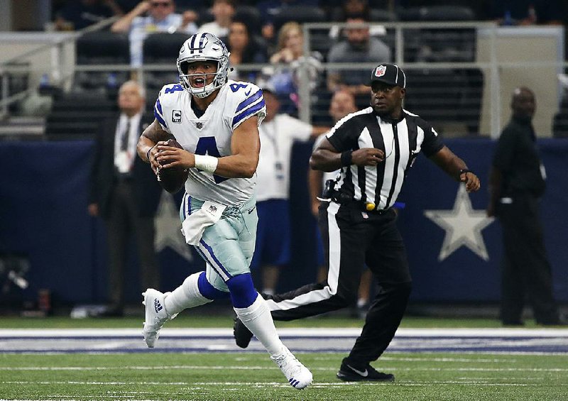 Cowboys quarterback Dak Prescott scrambles before throwing a pass in the first half Sunday against the Rams in Arlington, Texas. Prescott has been intercepted three times already this season after throwing just four picks last season.