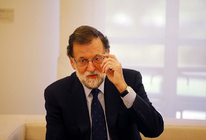 Spain's Prime Minister Mariano Rajoy gestures before a meeting with Spain's main opposition Socialist leader Pedro Sanchez at the Moncloa Palace in Madrid, Spain, Monday Oct. 2, 2017. 