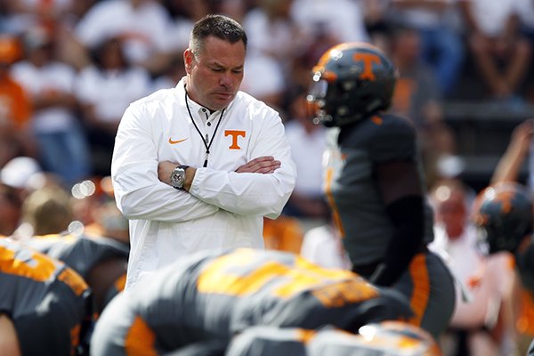 Tennessee head coach Butch Jones walks between his players before an NCAA college football game against Georgia, Saturday, Sept. 30, 2017, in Knoxville, Tenn. (AP Photo/Wade Payne)

