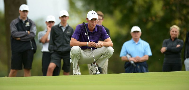 Fisher Vollendorf of Fayetteville eyes an eagle putt on the eighth hole Tuesday during the Class 7A boys state golf tournament at Fayetteville Country Club. Vollendorf missed the putt and tied with Cabot’s Connor Gaunt for medalist honors. 