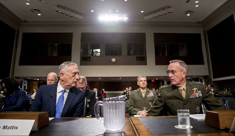 Defense Secretary James Mattis (left) and Gen. Joseph Dunford, chairman of the Joint Chiefs of Staff, prepare to testify Tuesday before the Senate Armed Services Committee.
