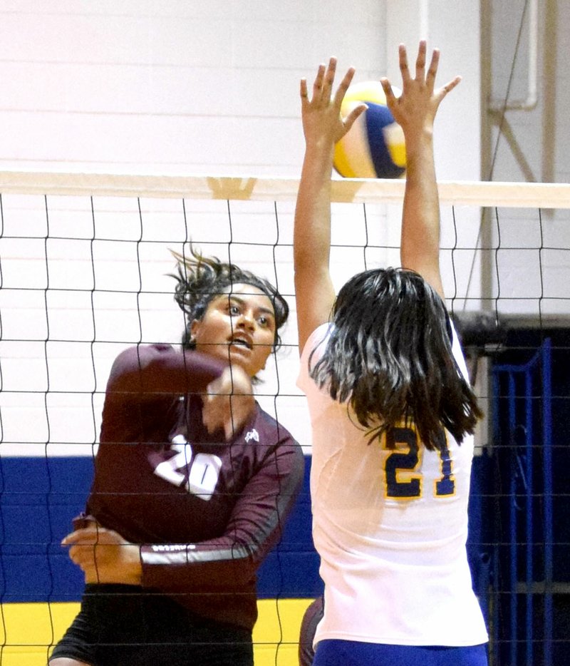 Photo by Mike Eckels Diana Reza knocked ball back to Lady Pioneer territory after Gentry&#8217;s Chastery Fuamatu (20) tried to spike it over Reza&#8217;s head during the Decatur-Gentry volleyball match at Peterson Gym in Decatur Sept. 26.