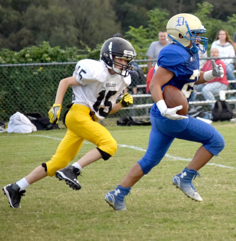 Photo by Mike Eckels Outrunning one final Jay tackle, Decatur&#8217;s Andres Revolorio (22) ran 40 yards for the only Bulldog touchdown of the Decatur-Jay junior high football game at Peterson Gym in Decatur Sept.29.