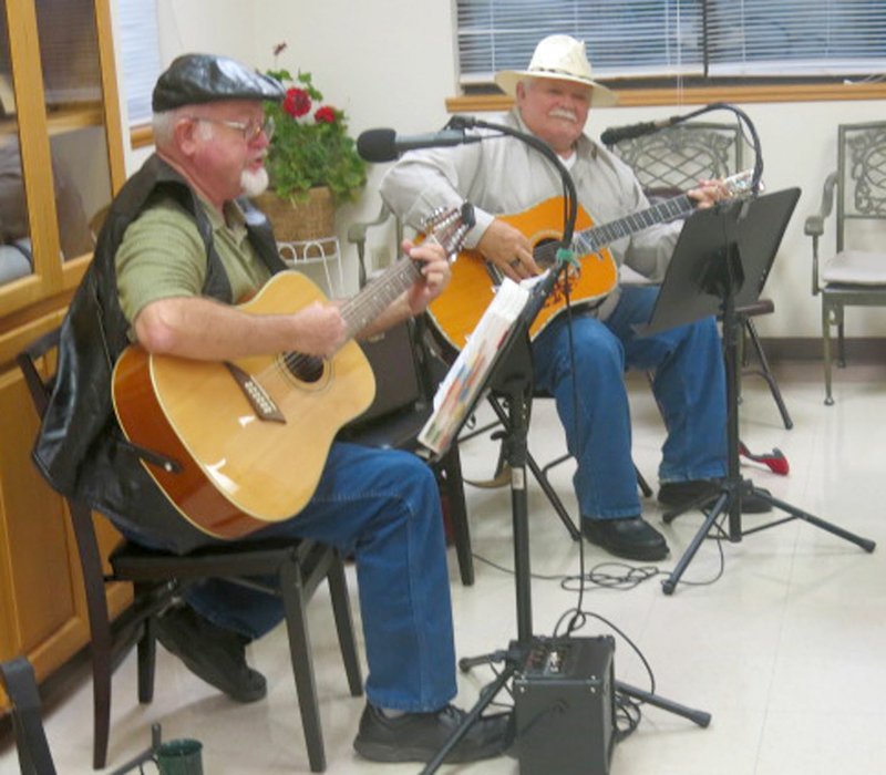 Photo by Susan Holland Al Blair, left, and Bill Mattler, two members of the Old Town String Band, provided musical entertainment at the Gravette Kiwanis Club meeting Monday, Sept. 25. Blair and Mattler performed three songs at the dinner meeting, concluding with &quot;Amazing Grace.&quot; Blair surprised those attending by singing the final verse in Cherokee.