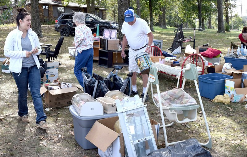 Photo by Mike Eckels Kailey Sutherland (left) watched over her parents&#8217; open-air booth as two visitors looked through the many items on sale during Pickin&#8217; Time on 59 events near the Decatur Salvage compound on the south side of Decatur Sept. 29.