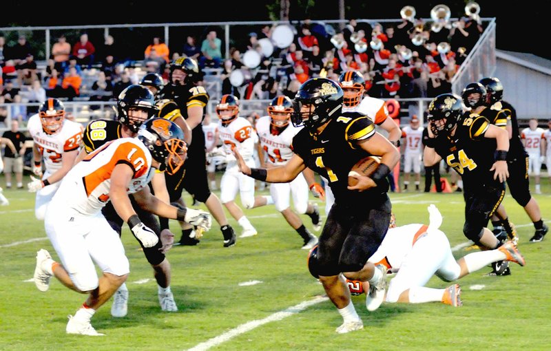 MARK HUMPHREY ENTERPRISE-LEADER Gravette&#8217;s Austin O&#8217;Brien confronts Prairie Grove halfback Anthony Johnson, who carried 13 times for 90 yards and two touchdowns in the Tigers&#8217; 31-7 Homecoming win over Gravette Friday.