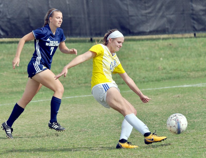 Photo courtesy of Little Joe Photography John Brown University senior Hannah Poor of Siloam Springs kicks the ball during the Golden Eagles&#8217; victory at Texas Wesleyan on Saturday in Fort Worth, Texas.