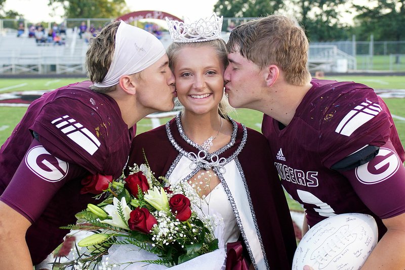 Photo by Randy Moll Lauren Fowler receives the ceremonial kiss from homecoming captains Jon Faulkenberry and Tanner Christie after she was crowned Gentry Homecoming Queen 2017 at special ceremonies preceding the homecoming football game in Pioneer Stadium on Friday.