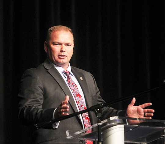 The Sentinel-Record/Richard Rasmussen STRIVE TO BE BETTER: Hot Springs Assistant Police Chief Chris Chapmond addresses a capacity crowd at the 28th annual Garland County Leadership Prayer Breakfast Tuesday morning in Horner Hall at the Hot Springs Convention Center. Chapmond spoke about his turbulent childhood, his military service, his decision to join the police department and his philosophy of always striving to be better every day.