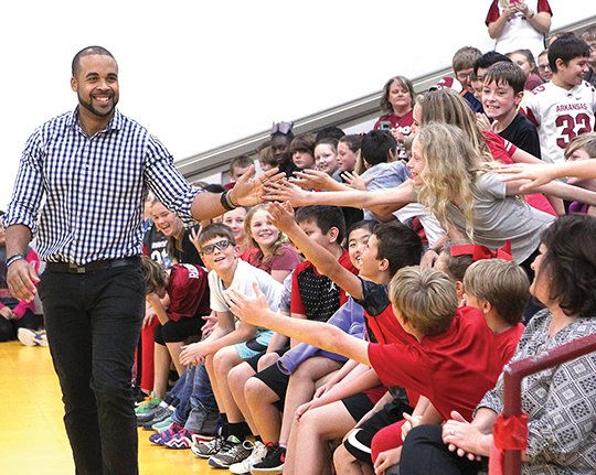 The Sentinel-Record/Richard Rasmussen RAZORBACK GREAT: Lake Hamilton Intermediate School students greeted television personality D.J. Williams, left, when he visited on Tuesday to speak about positive attitude and effort. Williams shared stories about his time as an All-American tight end for the Arkansas Razorbacks and playing in the NFL.