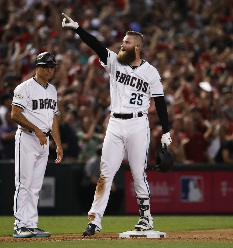 Arizona Diamondbacks relief pitcher Archie Bradley celebrates after his two-run triple against the Colorado Rockies during the seventh inning of Wednesday night’s National League wild-card game in Phoenix. The Diamondbacks won 11-8 to advance to the NL division series, where they will face the Los Angeles Dodgers starting Friday. 