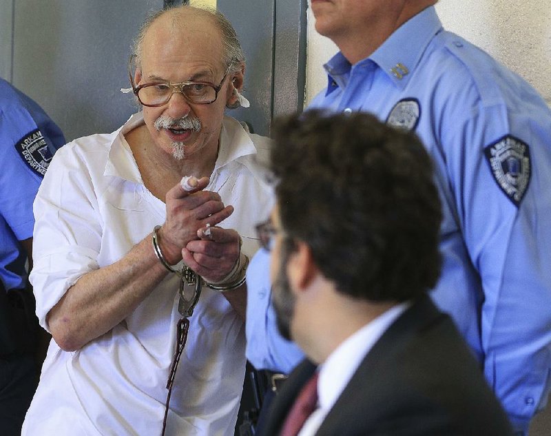 FILE — Condemned murderer Jack Greene talks about his lawyers, including John Williams (foreground), during a clemency hearing at the Arkansas Department of Correction’s Varner Unit.