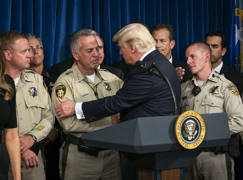 President Donald Trump thanks Clark County, Nev., Sheriff Joe Lombardo and other law enforcement officers Wednesday during his visit to the Metropolitan Police Department in Las Vegas. 