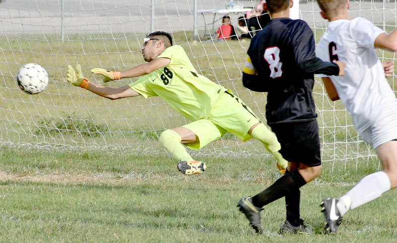 McDonald County goalie Uriel Lazaro dives in an attempt to block a shot during the Mustangs&#8217; 5-0 loss to Aurora on Sept. 28 at MCHS.