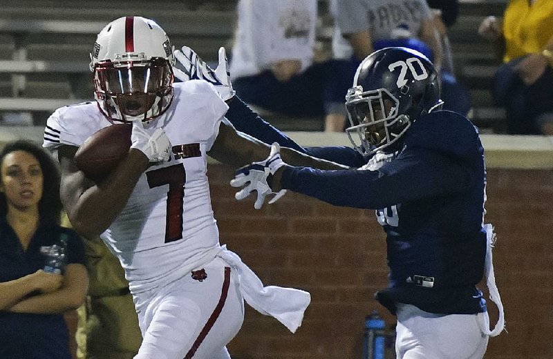 Arkansas State receiver Omar Bayless (7) makes a one-handed grab for a touchdown from quarterback Justice Hansen in Wednesday night’s 43-25 victory at Georgia Southern. Hansen threw four touchdown passes but also threw four interceptions.