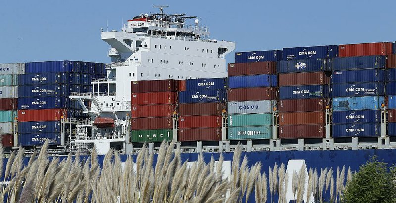 A container ship waits to be unloaded at the Port of Oakland, as seen from Alameda, Calif., in this file photo. The U.S. trade deficit narrowed to $42.4 billion in August, down $1.2 billion from July.