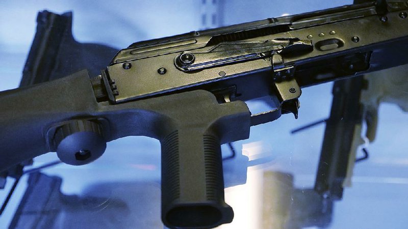 An assault rifle with a “bump stock” device is displayed Thursday at the Gun Vault store and shooting range in South Jordan, Utah.