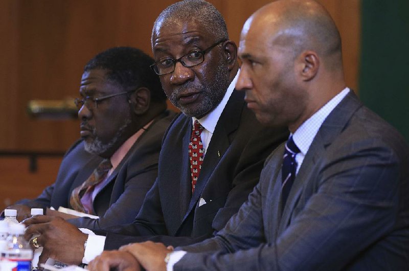 FILE — Circuit Judge Wendell Griffen (center) speaks on Oct. 5 during a news conference with attorneys Austin Porter Jr. (left) and Mike Laux announcing the filing of a federal First Amendment lawsuit against Arkansas Supreme Court justices for disciplining Griffen and barring him from hearing death-penalty cases.