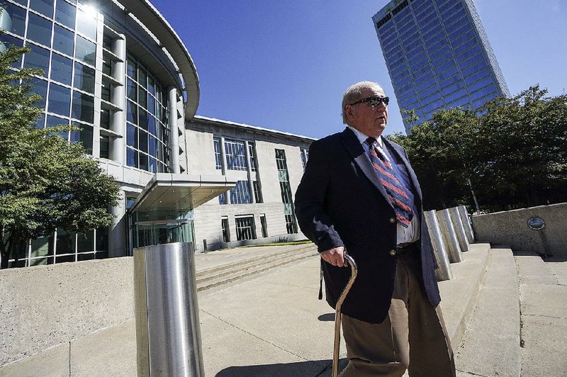 Joseph Boeckmann, who resigned in May 2016 as a district judge, leaves the federal courthouse in Little Rock with the aid of a cane Thursday after his guilty plea. He faces sentencing in about three months, and his attorney said Boeckmann could offer evidence on his age and health to seek a lighter sentence.