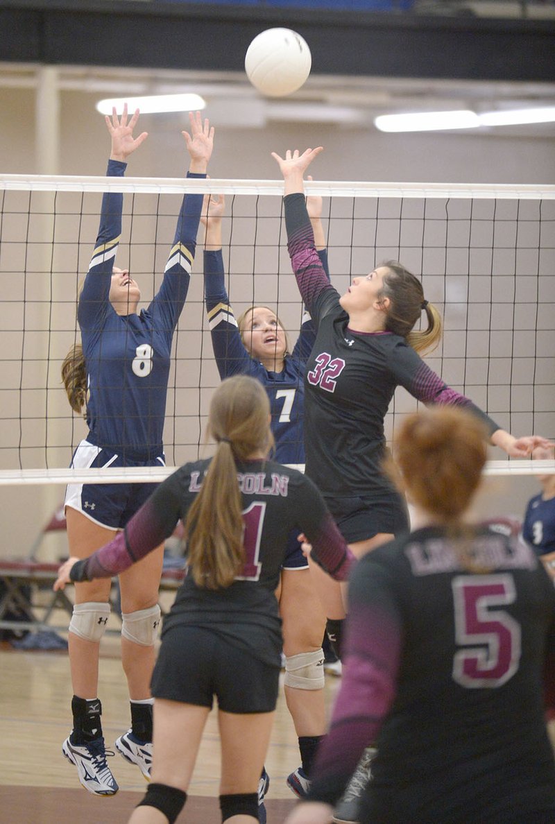 Lincoln’s Hollie Webb (32) tries to tip the ball over the net as Shiloh Christian’s Kate Turpin (8) and Jentry Lantzsch elevate for the block Thursday in Lincoln. Visit nwadg.com/photos for more photos from the match.