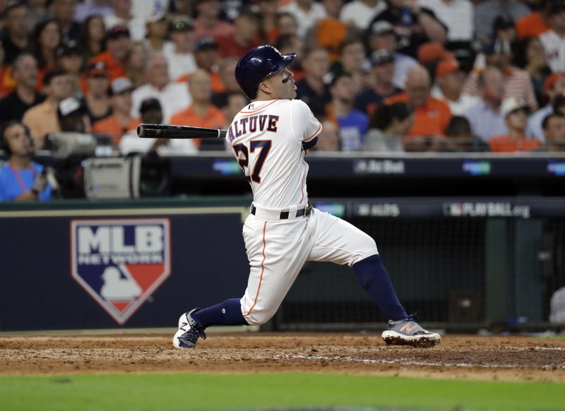 Houston Astros' Jose Altuve watches his a solo home run, his third of the game, against the Boston Red Sox in the seventh inning in Game 1 of baseball's American League Division Series, Thursday, Oct. 5, 2017, in Houston. 