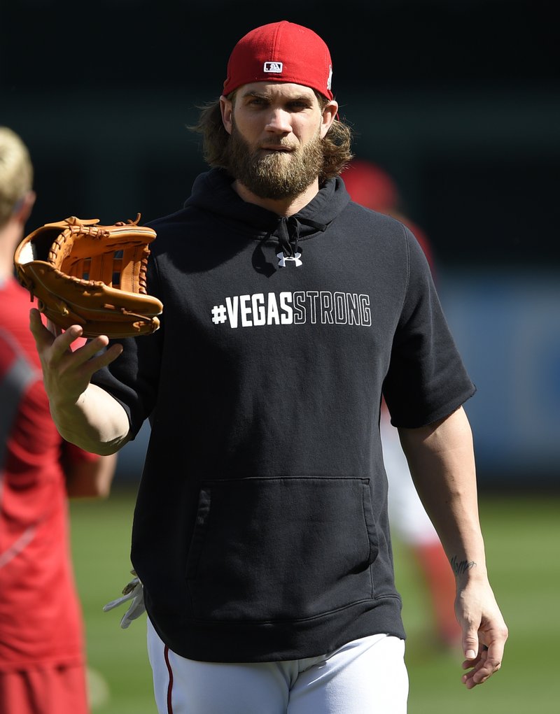 Washington Nationals' Bryce Harper walks on the field wearing a "#Vegas Strong" hoodie during baseball practice at Nationals Park, Thursday, Oct. 5, 2017, in Washington. The Nationals host the Chicago Cubs in Game 1 of the National League Division Series on Friday. 