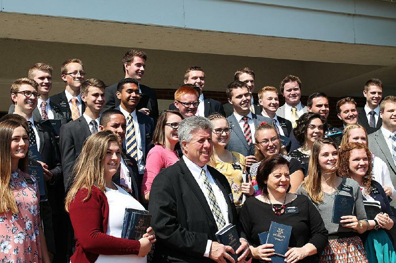 Norman and Karen Hansen (front center), leaders of the Arkansas Little Rock Mission of the Church of Jesus Christ of Latter-day Saints, stand with some of its missionaries as Renee Carr (not pictured), director of public affairs for the church, takes a group photo.