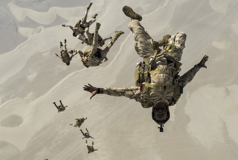 In this Aug. 21, 2017 photo released by the U.S. Defense Department, Qatari special operations personnel conduct a military free-fall Friendship Jump over Qatar.