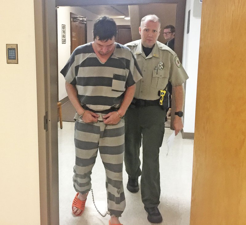 Charles Alan Rickman, 30, of Siloam Springs is led Friday into a courtroom at the Benton County Courthouse in Bentonville. Rickman is accused of raping a 69-year-old woman. Judge Brad Karren set Rickman’s bond at $250,000 at a bond hearing Friday morning.