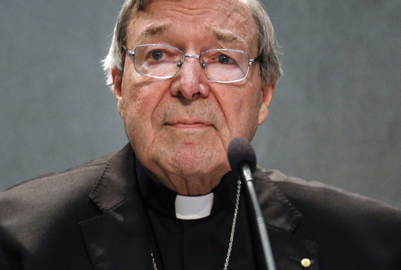 In this June 29, 2017 file photo, Cardinal George Pell meets the media, at the Vatican. Cardinal George Pell, the most senior Catholic official to face sex offense charges, was jeered by protesters as he made a court appearance on Friday, Oct. 6, 2017 in his native Australia. 