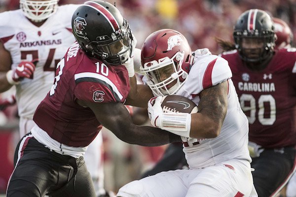 Arkansas running back Devwah Whaley (21) is tackled by South Carolina linebacker Skai Moore (10) during the first half of an NCAA college football game Saturday, Oct. 7, 2017, in Columbia, S.C. (AP Photo/Sean Rayford)