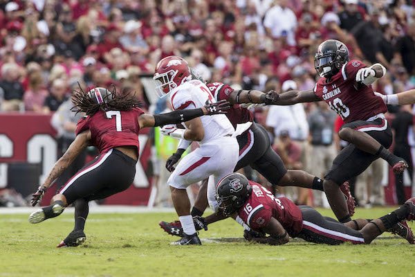 Chase Hayden (2), Arkansas running back, tries to evade a host of South Carolina defenders in the second quarter Saturday, Oct. 7, 2017, at Williams-Brice Stadium in Columbia, S.C. 