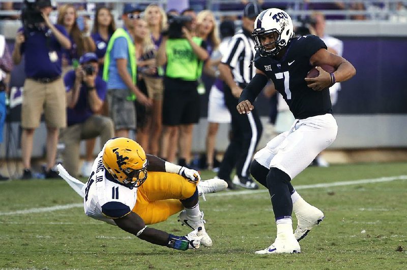TCU quarterback Kenny Hill (7) spins past West Virginia linebacker David Long Jr. to score a touchdown during the second half of the No. 8 Horned Frogs’ 31-24 victory over the No. 23 Mountaineers on Saturday in Fort Worth.