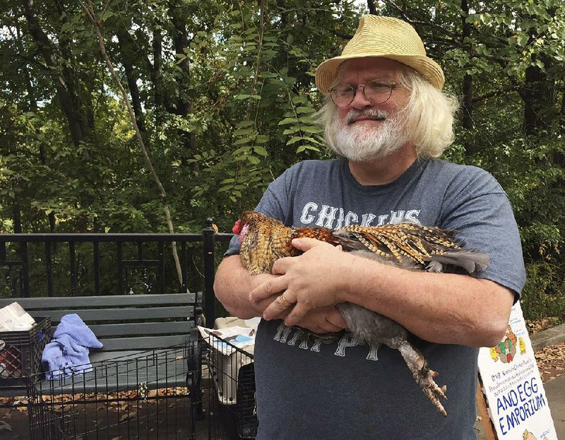 David Boyett shows one of the chickens from what he calls the “world’s smallest petting zoo” in Little Rock’s Hillcrest neighborhood on a recent Saturday. 