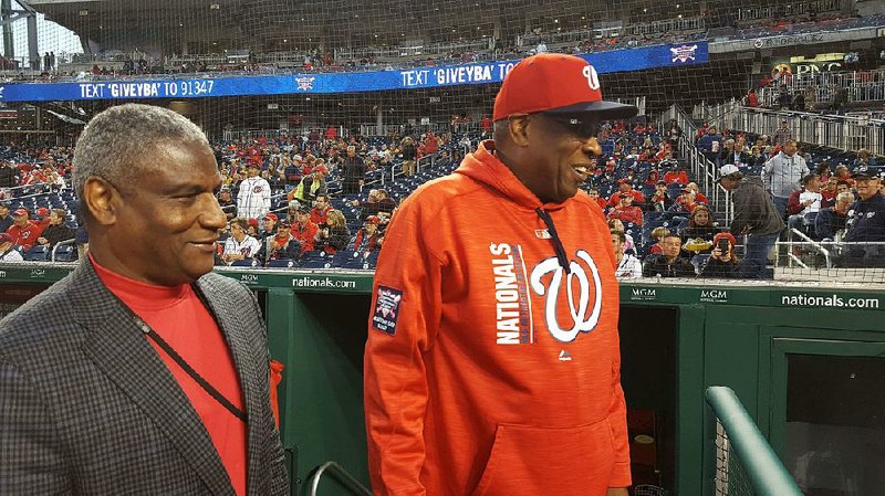 Rodney Slater (left) and Washington Nationals manager Dusty Baker get together before the start of a game Sept. 30 in Washington. Slater, a founding partner of the Nationals, was there to help promote the team’s youth baseball academy. 
