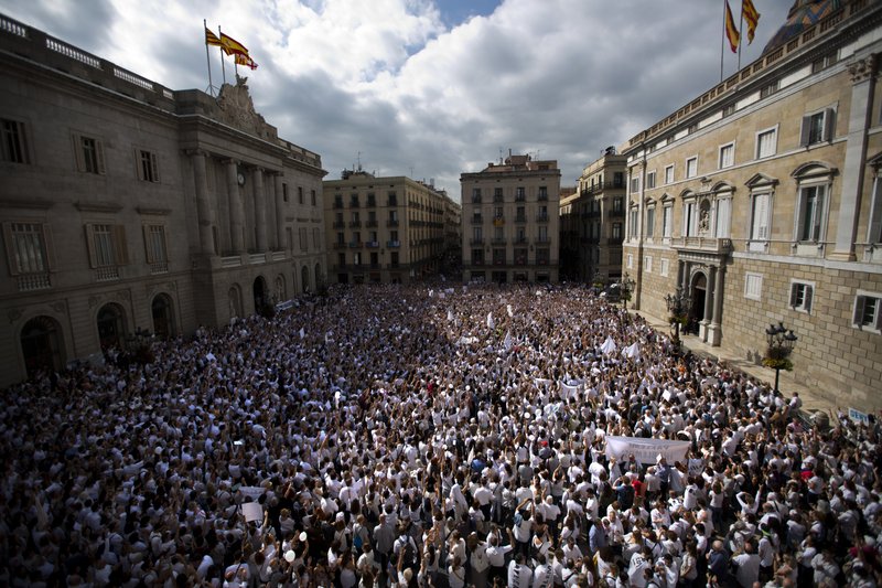 People gather during a protest in favor of talks and dialogue in Sant Jaume square in Barcelona, Spain, Saturday Oct. 7, 2017. Thousands gathered at simultaneous rallies in Madrid and Barcelona in a call for dialogue amid a political crisis caused by Catalonia's secession push. (AP Photo/Emilio Morenatti)