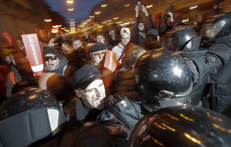 Protesters try to break through a riot police cordon during a rally in St. Petersburg, Russia, Saturday, Oct. 7, 2017. In a challenge to President Vladimir Putin on his 65th birthday, protesters rallied across Russia on Saturday, heeding opposition leader Alexei Navalny's call to pressure authorities into letting him enter the presidential race. (AP Photo/Dmitri Lovetsky)