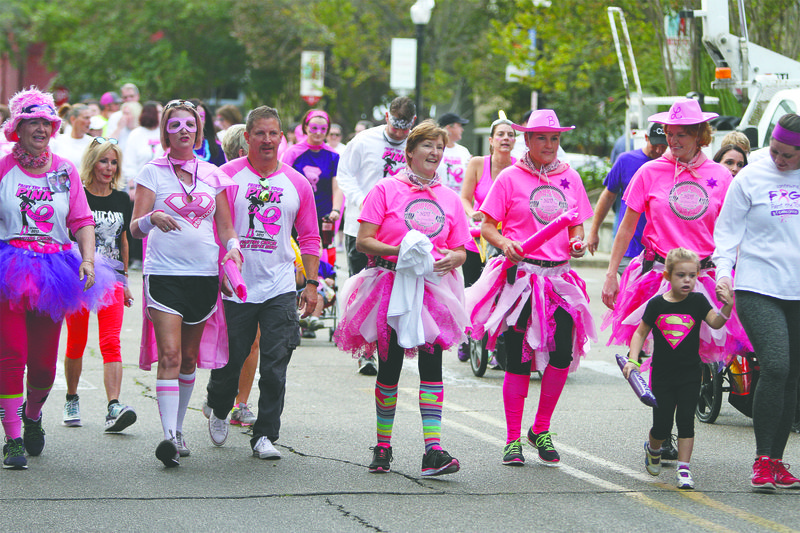 Going pink: Runners and walkers fill the streets of downtown El Dorado as the 2017 Paint the Town Pink 5k run/walk. The annual event is sponsored by #teamCorrie Cancer Foundation and raises funds to assist cancer patients.