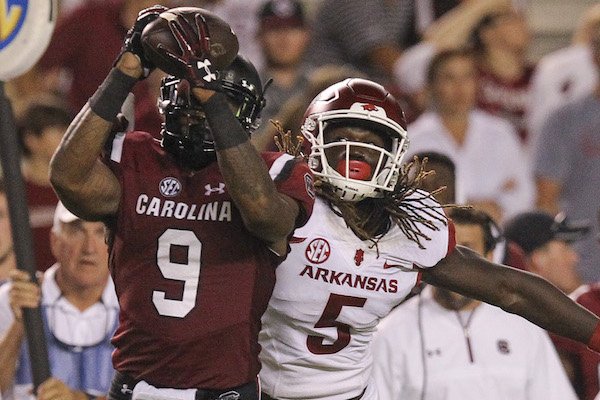 South Carolina's Keisean Nixon intercepts a throw to Arkansas wide receiver Brandon Martin (5) during the third quarter of the Razorbacks loss in South Carolina. Nixon scored a touchdown on the play. 