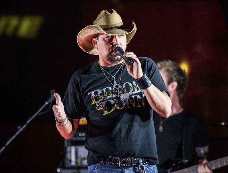 In this June 7, 2017 file photo Jason Aldean performs during a surprise pop up concert at the Music City Center in Nashville, Tenn.  