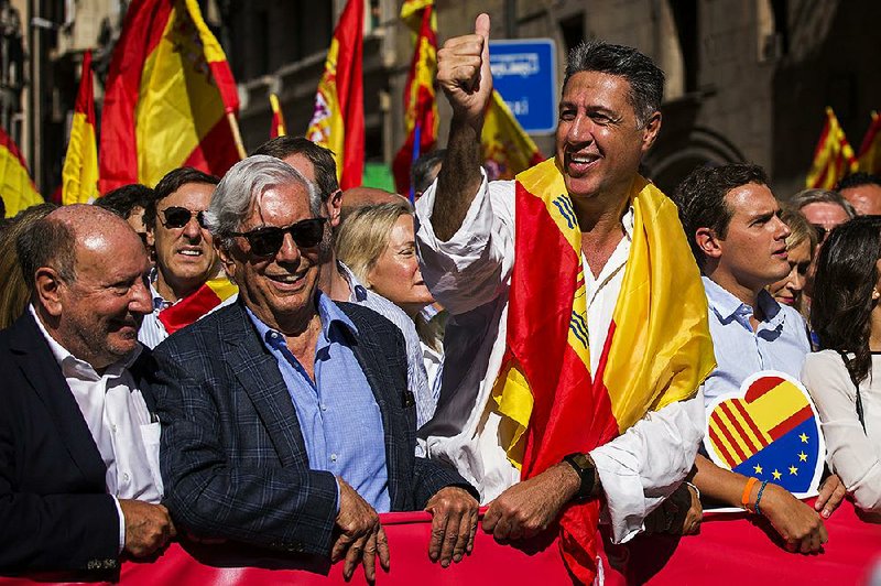 Nobel laureate Mario Vargas Llosa (center left) stands next to Popular Party leader in Catalonia Xavier Garcia Albiol (right) as they lead a march to protest the Catalan government’s push for secession from Spain on Sunday in downtown Barcelona.