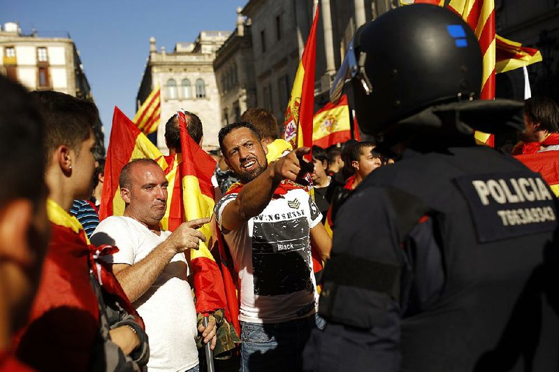 Demonstrators challenge Catalan regional police officers at the end of a march Sunday in downtown Barcelona, Spain, to protest the Catalan government’s push for secession from the rest of Spain.