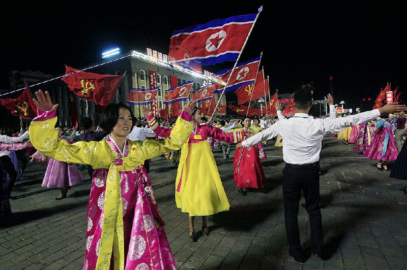 North Koreans participate in a mass dance event marking the 20th anniversary of the election of former leader Kim Jong Il as general secretary of the Workers’ Party, which is the founding and ruling party of North Korea, at Kim Il Sung Square on Sunday in Pyongyang.

