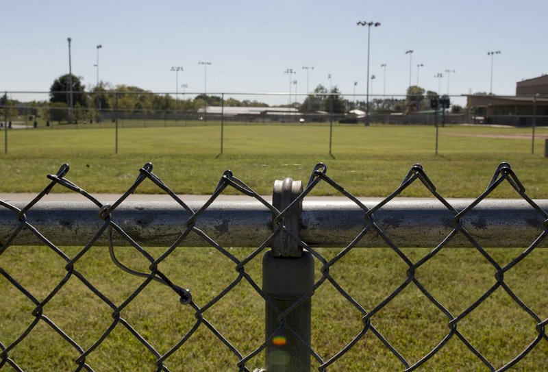 A fence is shown Sunday at Memorial Park in Bentonville. Visit Bentonville is partnering with the Bentonville Parks and Recreation Department to get new fencing around the ballfields at Memorial Park.