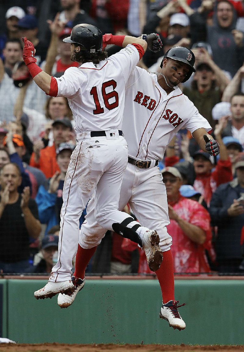 Boston’s Andrew Benintendi (Arkansas Razorbacks) celebrates with Xander Bogaerts (right) after hitting a two-run home run in the fifth inning that put the Boston Red Sox ahead 3-2. Houston would rally to win 5-4 and win the American League division series.